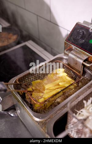 Dirty cooking area with french fries deep fryer Stock Photo