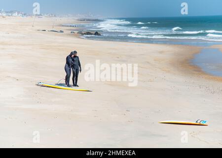 Surfers in landscape at Sea Girt beach in New Jersey USA Stock Photo