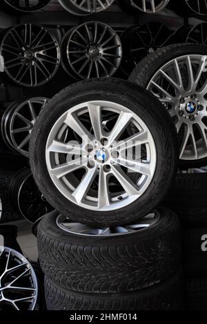 Car wheels with new tires in the store. A wide range of alloy wheels for cars. Repair and replacement. Anapa, Russia-22.05.2021 Stock Photo