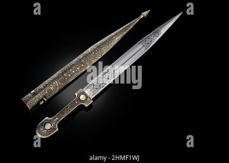 souvenir collectible silver dagger with scabbard on black. Luxury ...
