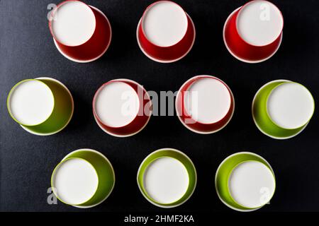 Creative minimalistic composition, pattern of inverted paper cups on a black background, coffee, ecology concepts, recycling Stock Photo