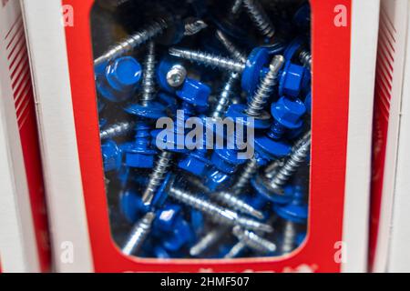 Blue roofing self-tapping screws, color hat with a rubber lining, roofing self-tapping drill. Stock Photo