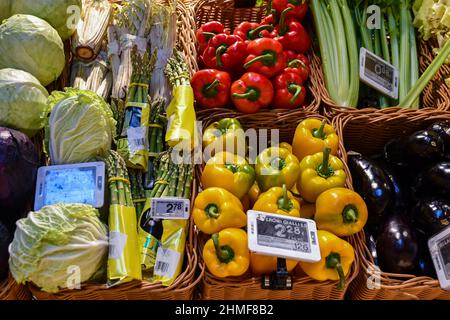 Close-up of vegetables exposed in wicker baskets (peppers, asparagus, cabbage, eggplant, celery) in the Fiorfood Coop store, Turin, Piedmont, Italy