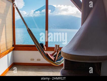 View of San Pedro volcano and Lake Atitlan from a hammock, San Marcos, Guatemala Stock Photo