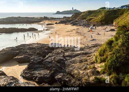 Godrevy,Cornwall,England-July 22nd 2021: Families enjoy the hot,sunny summer afternoon sun,while playing on the sandy bay,also popular with surfers,wi Stock Photo