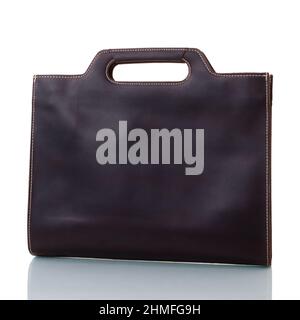 Brown leather bag of rectangular shape with cut-through handles. On a white background Stock Photo
