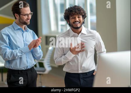 Two men standing in front of camera and looking involved Stock Photo