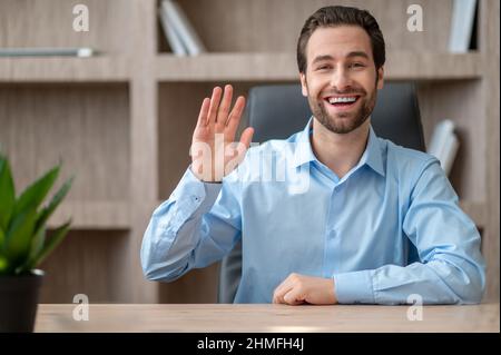 A manager in a blue shirt feeling joyful and happy Stock Photo