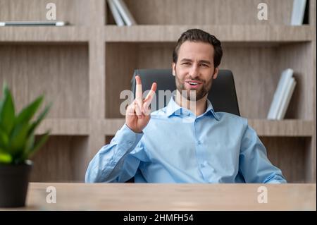 A manager in a blue shirt feeling joyful and happy Stock Photo