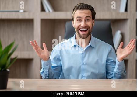 A manager in a blue shirt feeling joyful and happy Stock Photo