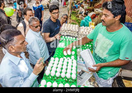 Mumbai India,Lower Parel,Sunday Market,produce stall vendor shopping shopper,market marketplace selling display sale eggs man men paying buying Stock Photo