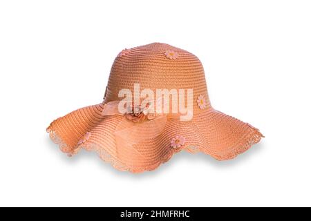 Women's straw beach hat on the sand at the beach, blue sea and