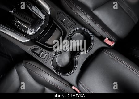 Modern Car Interior Central Console with Cup Holders and Front Seats. Automotive Theme. Stock Photo