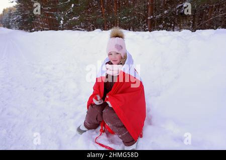 the girl is wrapped in the flag of Canada Stock Photo