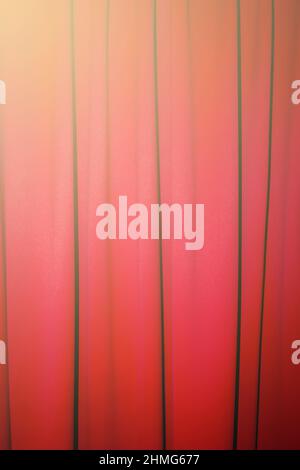 Red closed curtain with a light spot use for background Stock Photo