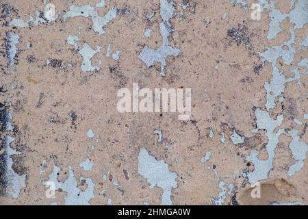 Old beige paint with cracks on brick wall as background, texture, selective focus Stock Photo