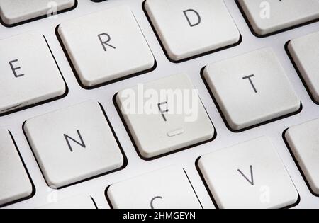 Non-fungible token or NFT concept, NFT spelled out on computer keyboard Stock Photo
