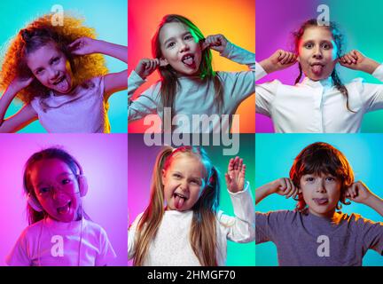 Making faces. Set of portraits of little cute kids, boys and girls isolated on multicolored studio background in neon light. Education, wow emotions Stock Photo