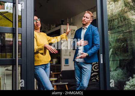 Boyfriend and girlfriend are arguing at home. Man and woman are having fight misunderstanding or quarrel. Couple having problems in relationship. Mone Stock Photo