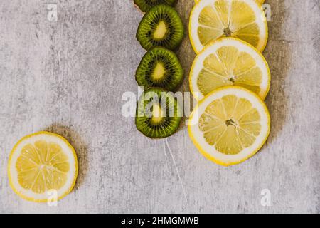 Lemons and kiwis . Seamless pattern of lemons on an industrial background. Stock Photo