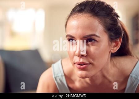Close Up Of Woman In Fitness Clothing At Home In Lounge Doing Press Ups Stock Photo