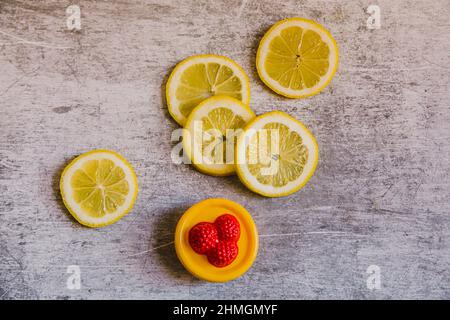 Lemons and plastic toy . Seamless pattern of lemons on an industrial background. Stock Photo