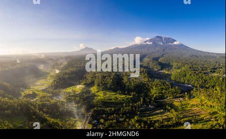 Dramatic aerial view of the Mt Agung volcano overlooking a terrace rice paddies near Ubud in Bali, Indonesia Stock Photo
