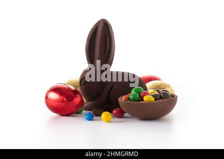 Easter chocolate bunny and colorful eggs isolated on white background Stock Photo