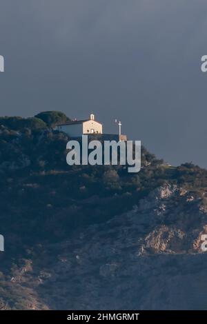 Vertical view of the church of Castellare, Pisa, Italy, against a sky with dark clouds Stock Photo