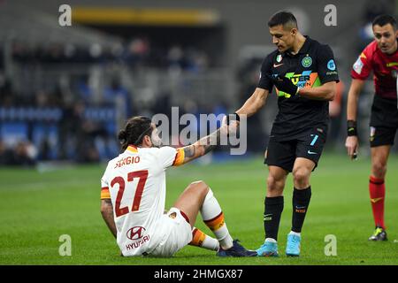 Milano, Italy. 08th, February 2022. Alexis Sanchez (7) of Inter gives a hand to Sergio Oliveira (27) of Roma during seen in the Coppa Italia match between Inter and Roma at Giuseppe Meazza in Milano. (Photo credit: Gonzales Photo - Tommaso Fimiano). Stock Photo