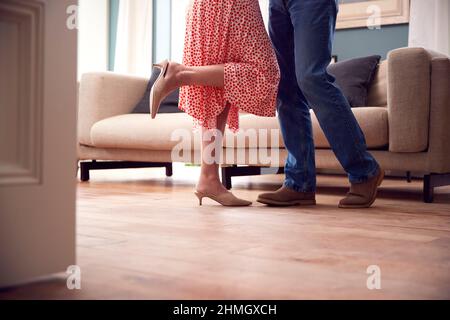 Close Up On Legs As Romantic Senior Retired Couple Dancing In Lounge At Home Together Stock Photo