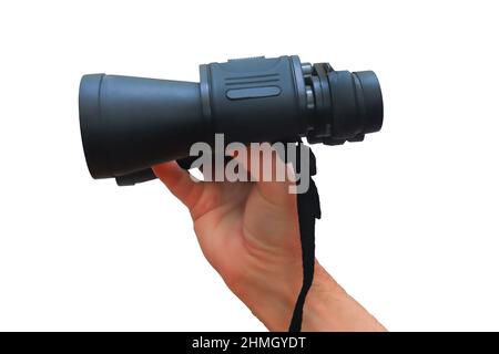 Black binoculars in the man's hand are close-up. Optical device for observation at a distance. Isolate on a white background. Stock Photo