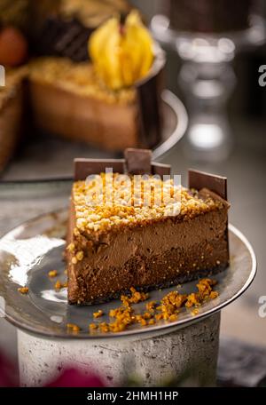 Close up of layered chocolate mousse cake with caramelized nut on top Stock Photo