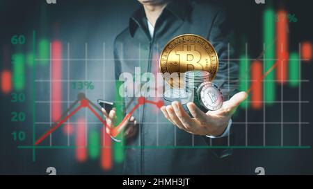 Businessman holding bitcoin on cyberspace background - bit coin BTC the new virtual money.man's hand holding golden Bitcoin Stock Photo