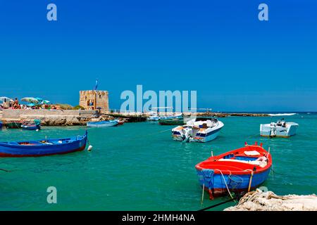 Fishing boats float on the water in Polignano a mare Stock Photo