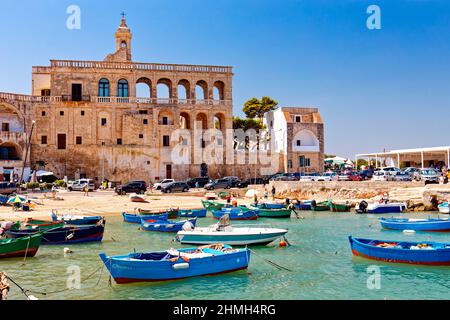 Fishing boats float on the water in Polignano a mare Stock Photo