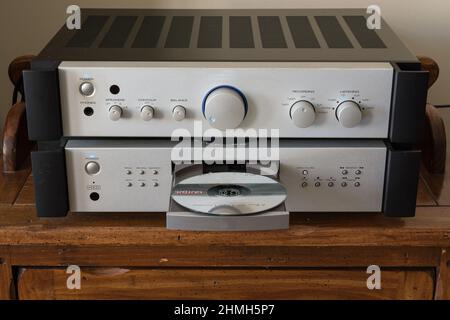 Compact Disc Player - a high quality Compact Disc (CD) player with a matching amplifier in brushed aluminum. Front view with CDs on view in open tray. Stock Photo