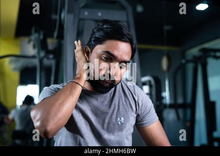 close up shot of young man with washing sweat after heavy workout at gym - concept of tireless hardworking, relaxing, taking break and determination Stock Photo