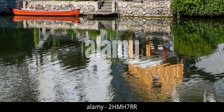 Boat with reflections in the water, Altmuehl, Markt Essing, Altmuehltal, Bavaria, Germany, Europe Stock Photo