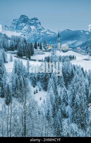 Italy, Veneto, Belluno, the village of Selva di Carore in winter with the mount Pelmo in the background, Dolomites Stock Photo