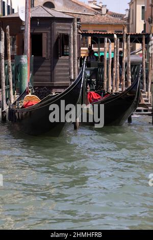 Two gondolas at a pier on the Grand Canal in Venice, Italy Stock Photo