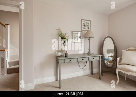 Newport, Essex - March 21 2019: Luxury modern interior detail within staged new home with sideboard and chair. Stock Photo