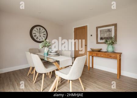 Newport, Essex - March 21 2019: Luxury modern interior dining room within staged new home with sideboard and dressed table Stock Photo