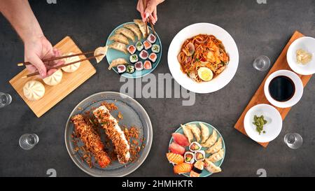 Overhead View Of Couple In Chinese Restaurant Eating Meal Together