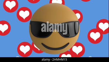 Face wearing sunglasses emoji over multiple red heart icons floating against blue background Stock Photo