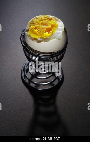 Happy Different Individual Concept Single Egg With Smiley Face In Striped Egg  Cup In Front Of Ten Boiled Eggs In White Egg Cups On A Wooden Table Stock  Photo - Download Image
