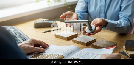 customer chooses door design and hardware in door store Stock Photo