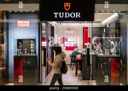 A shopper walks past a Swiss watchmaker manufacturer and brand