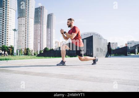 Determined man listening to music and warming up Stock Photo