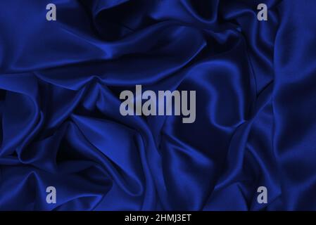 Rich and luxury red silk fabric texture background. Top view. Stock Photo